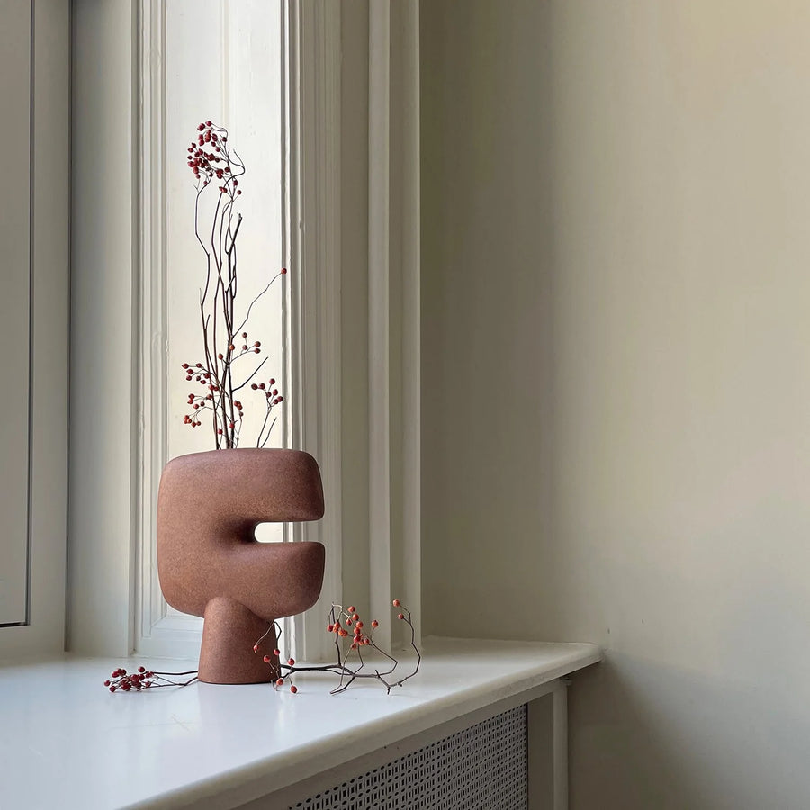Ceramic sculptural vase with branches on a windowsill from 101 Copenhagen
