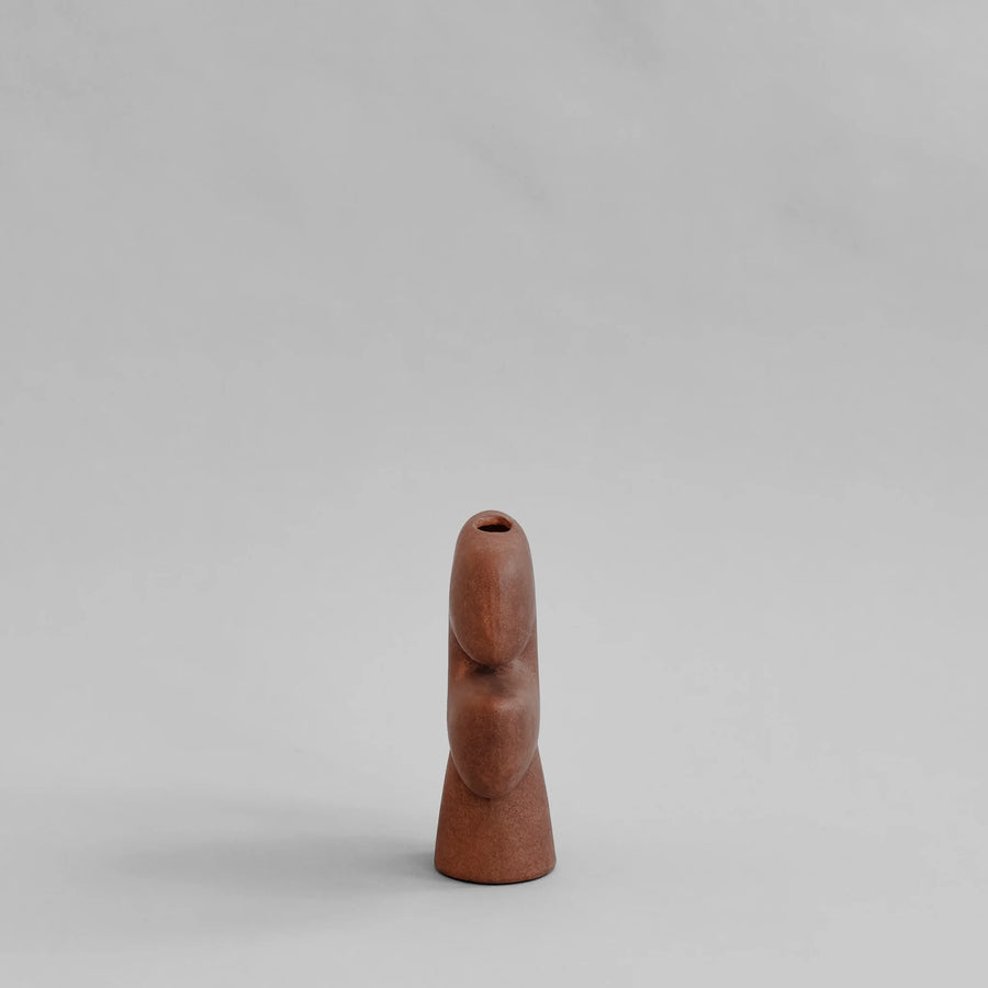 Side view of a terracotta colour ceramic vase on a light gray background from 101 Copenhagen at Spacio retail stores in Mumbai & Kolkata. 