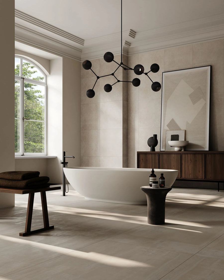 Modern bathroom with a freestanding bathtub, wooden cabinet, and decorative lighting fixture.