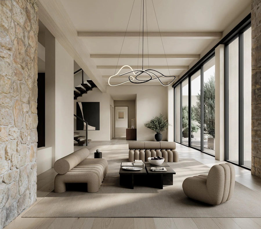 Modern living room with stone wall, large windows, and stylish furniture.