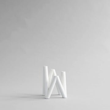 White candle stand on a light gray background from 101 Copenhagen at Spacio retail stores in Mumbai & Kolkata. 