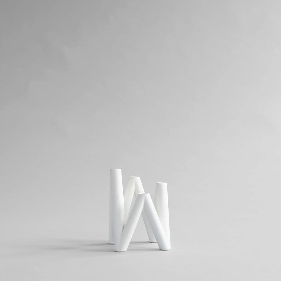 White candle stand on a light gray background from 101 Copenhagen at Spacio retail stores in Mumbai & Kolkata. 
