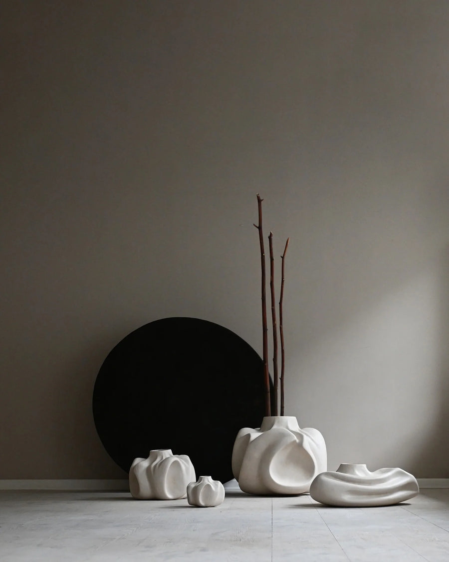 Set of white ceramic vases on a neutral background from 101 Copenhagen at Spacio retail stores in Mumbai & Kolkata. 