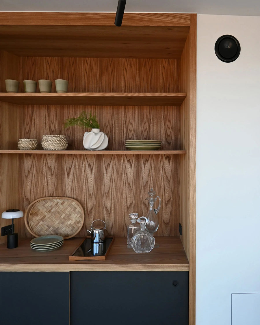 Wooden shelf with decorative items in a kitchen setting