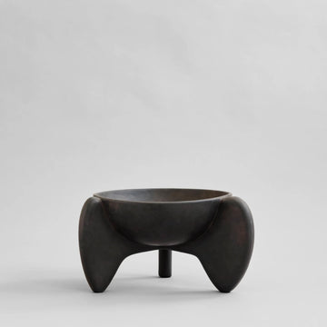 Black ceramic bowl with unique design on a light gray background from 101 Copenhagen at Spacio retail stores in Mumbai & Kolkata. 
