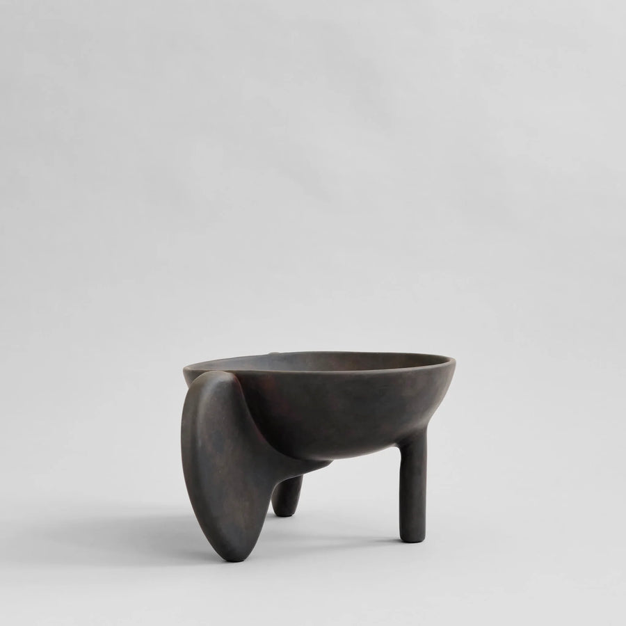 Black ceramic bowl with unique design on a light gray background from 101 Copenhagen at Spacio retail stores in Mumbai & Kolkata. 