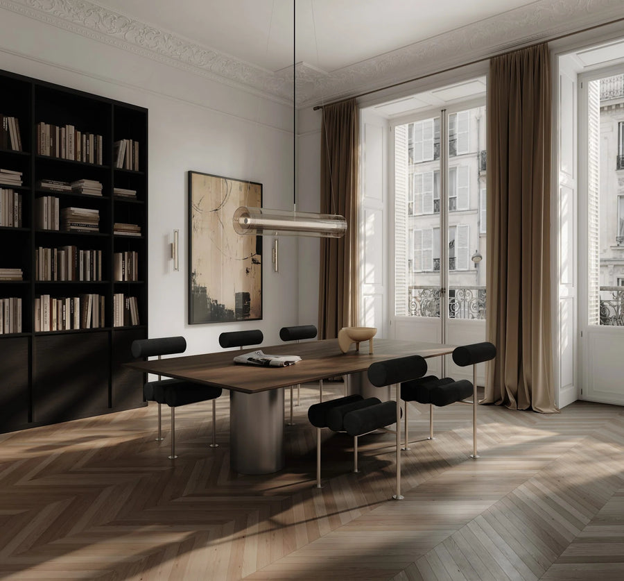 Modern dining room with a large window, bookshelf, and wooden table.