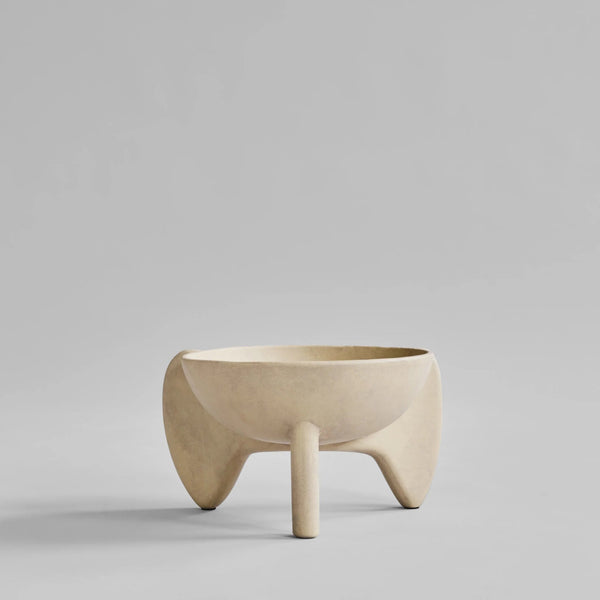Beige ceramic bowl on a gray background from 101 Copenhagen at Spacio retail stores in Mumbai & Kolkata. 