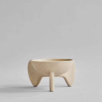 Beige ceramic bowl on a gray background from 101 Copenhagen at Spacio retail stores in Mumbai & Kolkata. 