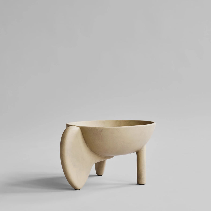 Beige ceramic bowl with unique design on a gray background from 101 Copenhagen at Spacio retail stores in Mumbai & Kolkata. 