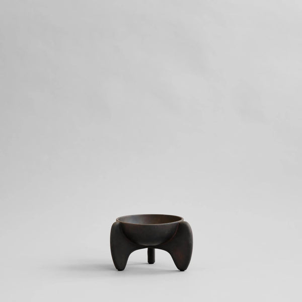 Small black ceramic bowl on a light gray background from 101 Copenhagen at Spacio retail stores in Mumbai & Kolkata. 