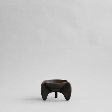 Small black ceramic bowl on a light gray background from 101 Copenhagen at Spacio retail stores in Mumbai & Kolkata. 