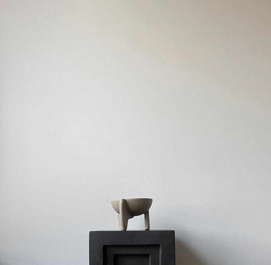 Small ceramic bowl on a black pedestal against a plain white wall from 101 Copenhagen at Spacio retail stores in Mumbai & Kolkata. 
