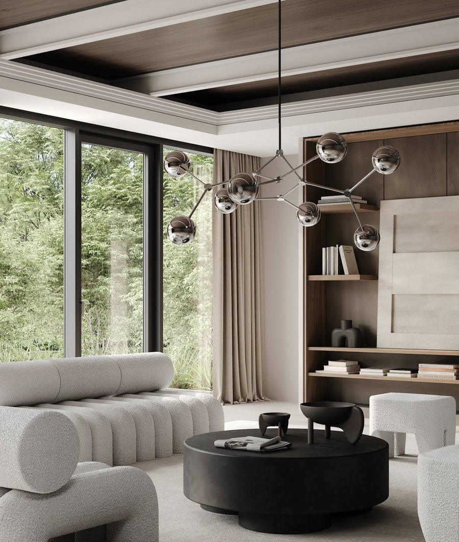 Modern living room with a chandelier, sofa, and coffee table.
