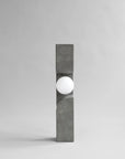 Modern outdoor floor lamp with concrete base and white globe on a gray background from 101 Copenhagen at Spacio retail stores in Mumbai & Kolkata. 