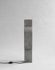 Rectangular concrete block with a black cord on a white background from 101 Copenhagen at Spacio retail stores in Mumbai & Kolkata. 