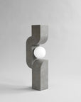 Concrete lamp with a spherical light bulb on a gray background from 101 Copenhagen at Spacio retail stores in Mumbai & Kolkata. 