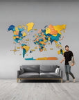 2XL size wooden world map on a grey wall above a grey colour sofa