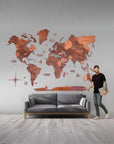 Man standing next to a 3XL size wooden world map in a living room.