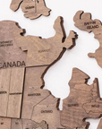 Different angle of Luxury wooden terra World Map as wall sculpture from 'Enjoy The Wood' on a white back ground for modern office and home interiors available at Spacio India from Office Accessories collection.