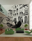 Black-and-white fresco of a gondolier in Venice, handcrafted in Italy on plaster with Carrara marble and Roman travertine powder, from Spacio's Luxury Art Surface collection, in front of a green sofa in a double height living room