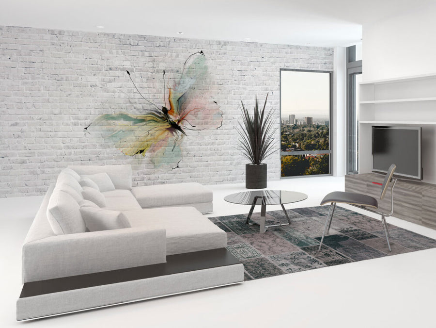 A fresco mural of a watercolour butterfly in pastel hues on a textured brick wall, crafted by hand in Italy with Carrara marble and travertine plaster. Featured on a wall in a modern design living room