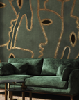 A living room with an Affreschi wall design featuring a green and gold mural from the Affreschi Season 1 Collection.