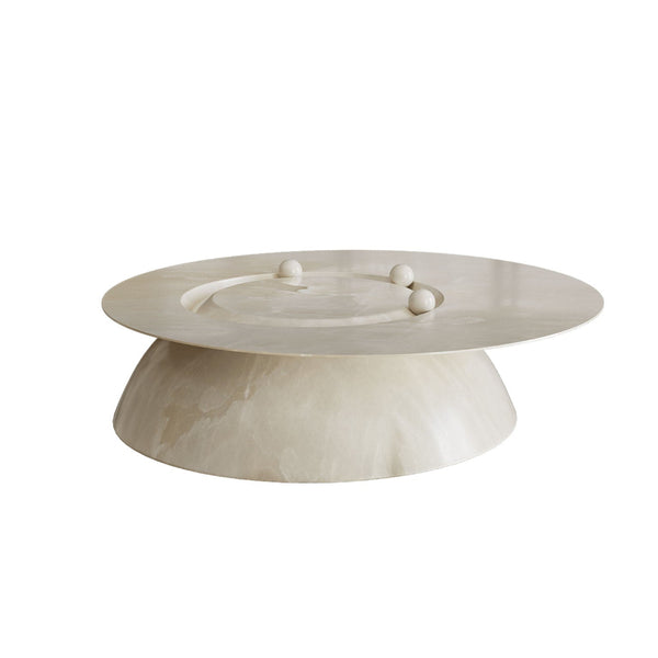White ceramic cake stand with three small spherical decorations on a white background