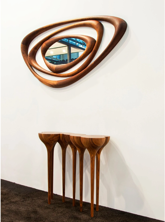 An Agrippa Esgrimas Console table with a mirror on it, featuring naturalistic concept and simple shapes.
