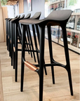 A row of Agrippa Morgan bar stools in a store.