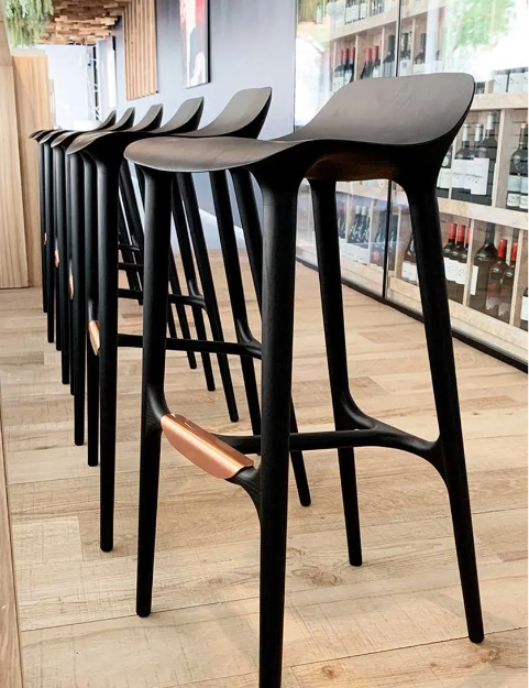 A row of Agrippa Morgan bar stools in a store.