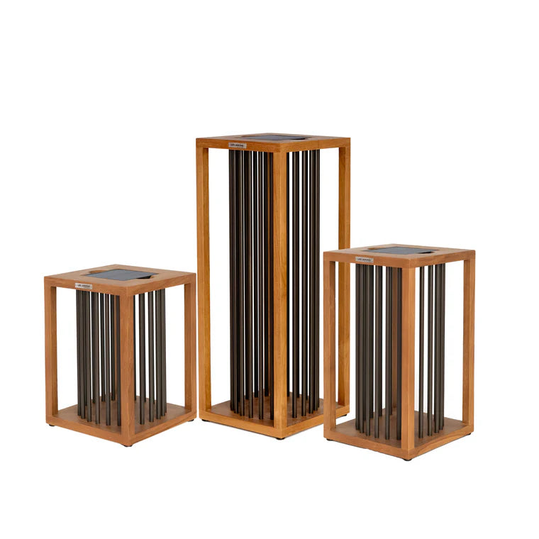 Three wooden solar lanterns with cylindrical metal rods on a white background  by Les Jardins available at Spacio retail stores in Mumbai & Kolkata. 