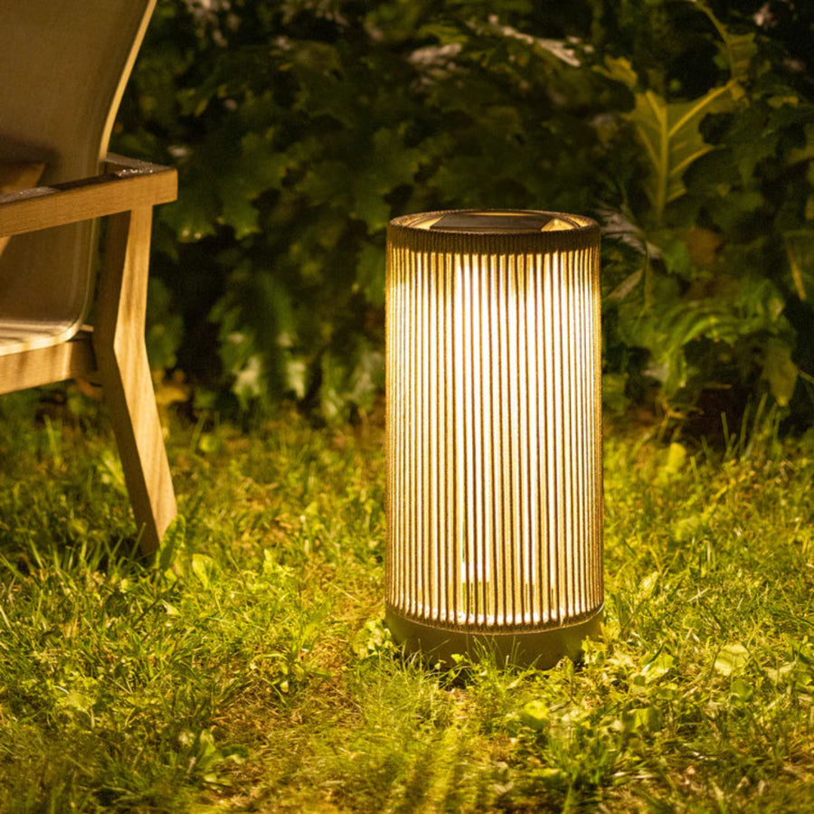Garden solar lantern on grass with bench and plants in the background by Les Jardins available at Spacio retail stores in India.