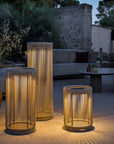 Set of three woven outdoor indoor solar lanterns on a patio with evening lighting by Les Jardins available at Spacio retail stores in India.