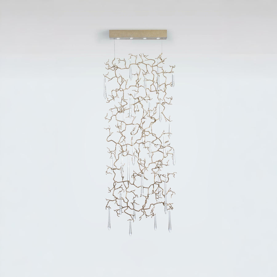 A light screen curtain suspending from the ceiling with clear water drop shaped glass hanging on golden colour branches