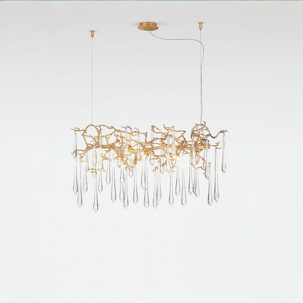 Glass droplet chandelier in gold finish on a light grey colour back ground