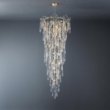 A grand conical chandelier suspending from ceiling with glass drop shaped glass hanging on gold colour branches