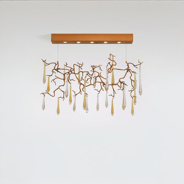 Modern chandelier with gold branches and clear hanging elements on a white background