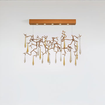 Modern chandelier with gold branches and clear hanging elements on a white background