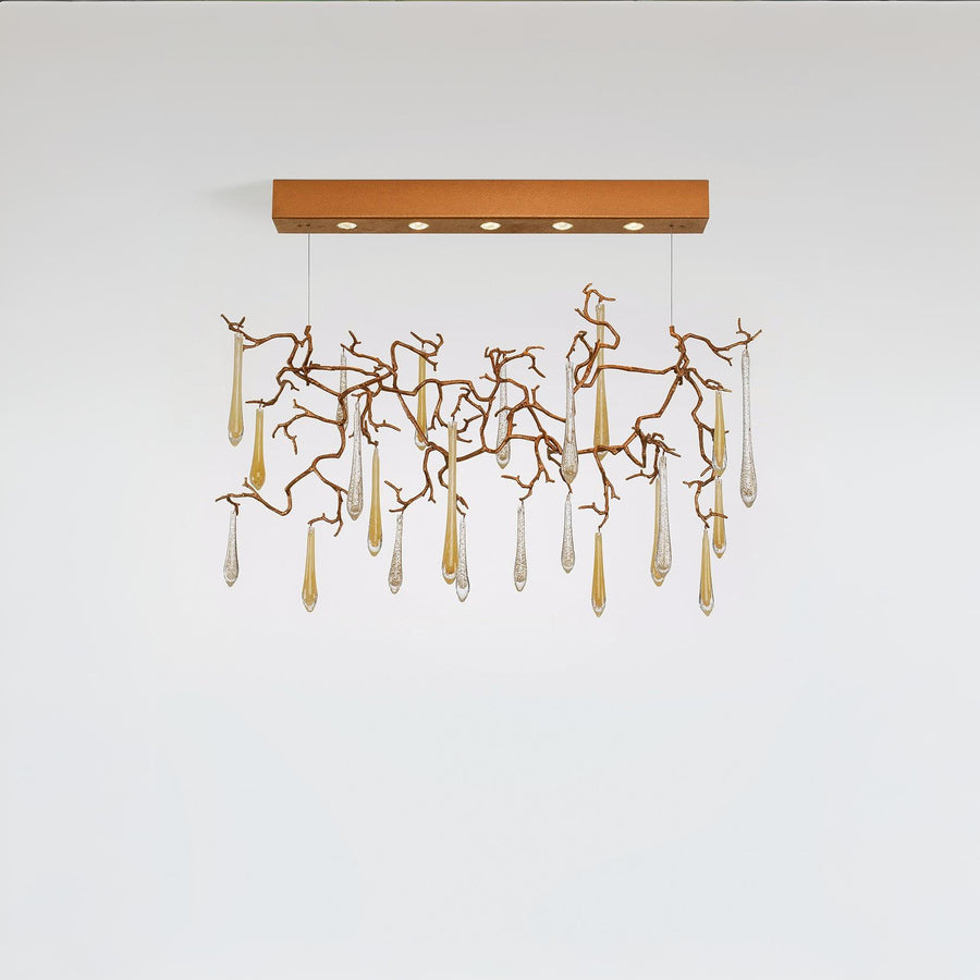 Modern chandelier with gold branches and clear hanging elements on a white background