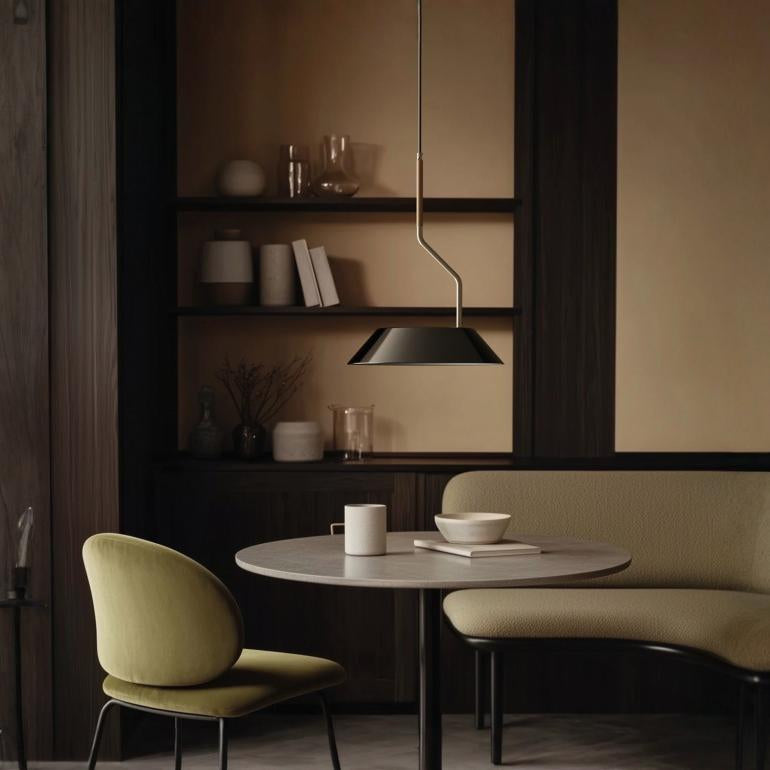 A modern interior with sofa, chair, table and a hanging pendant lamp. 