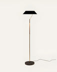 Floor lamp with black shade and gold base on a white background from Aromas Del Campo available at Spacio retail stores in Mumbai & Kolkata. 