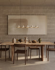 Dining area with wooden table and chairs against a textured wall.