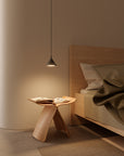 A modern theme bedroom with a pendant lamp hanging on the bed side table. 