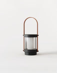 A lantern shaped cordless lamp on a white background from Aromas Del Campo available at Spacio in India. 
