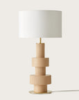 A modern design table lamp in beige colour on a light cream colour background from Aromas Del Campo available at Spacio retail stores in Mumbai & Kolkata. 