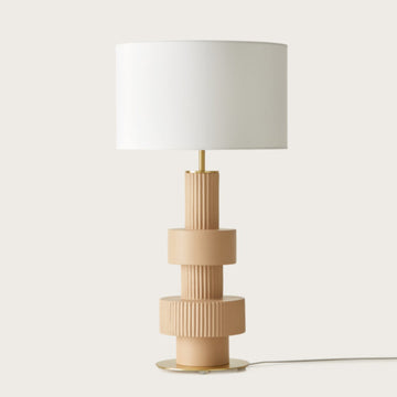A modern design table lamp in beige colour on a light cream colour background from Aromas Del Campo available at Spacio retail stores in Mumbai & Kolkata. 