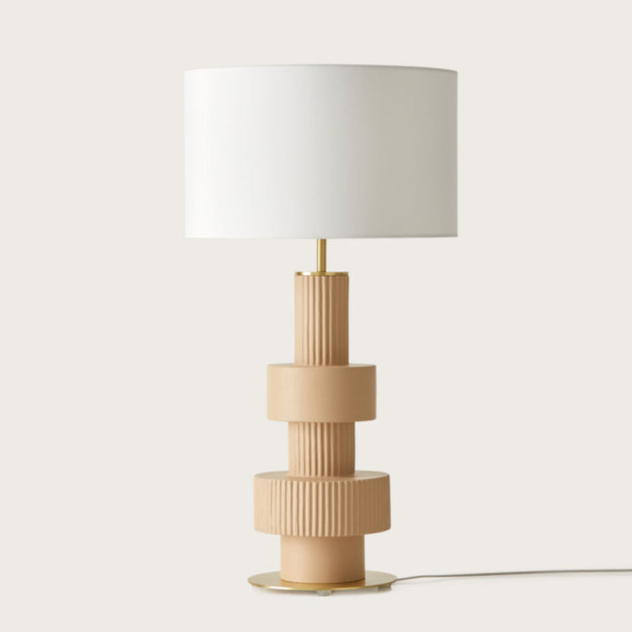 A modern design table lamp in beige colour on a light cream colour background from Aromas Del Campo available at Spacio retail stores in Mumbai & Kolkata. 