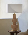 A modern table lamp on a wooden side table 