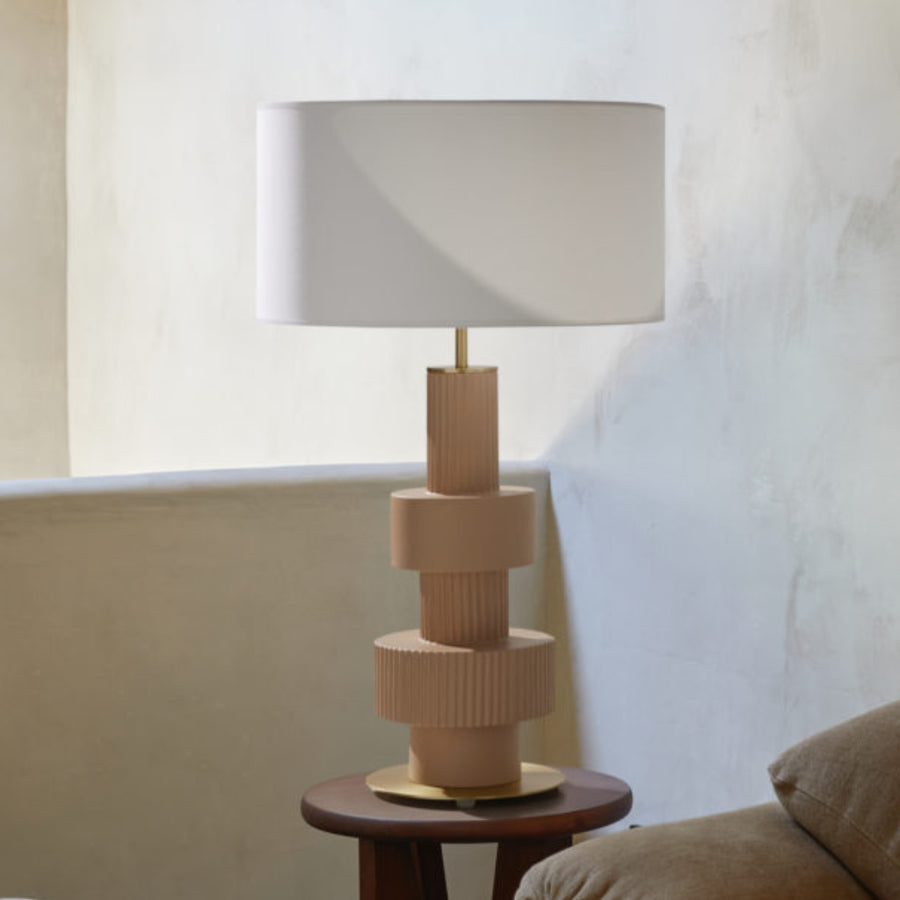A modern table lamp on a wooden side table 